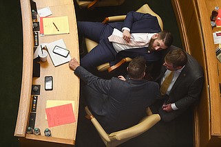 (From top) State Representatives Stetson Painter, R-Mountain Home, Trey Steimel, R-Pocahontas, and Bart Schulz, R-Cave City, talk at their desks during a meeting of the House of Representatives at the state capitol on Wednesday, April 17, 2024..(Arkansas Democrat-Gazette/Stephen Swofford)